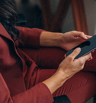 Close-up of a professional using a mobile device at 260 Madison Avenue, symbolizing the ease of connection and immediate assistance available for leasing inquiries and building management.