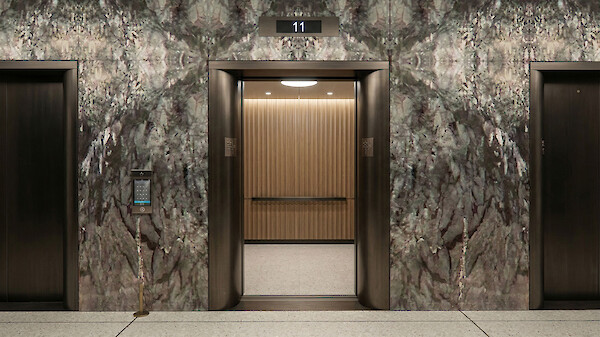 Modern elevator lobby at 260 Madison Avenue featuring luxury marble wall cladding and contemporary finishes on the 11th-floor amenity level.