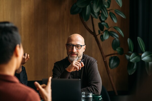 Professionals meeting in a modern, wood-paneled lounge at 260 Madison Avenue office amenities in Midtown Manhattan